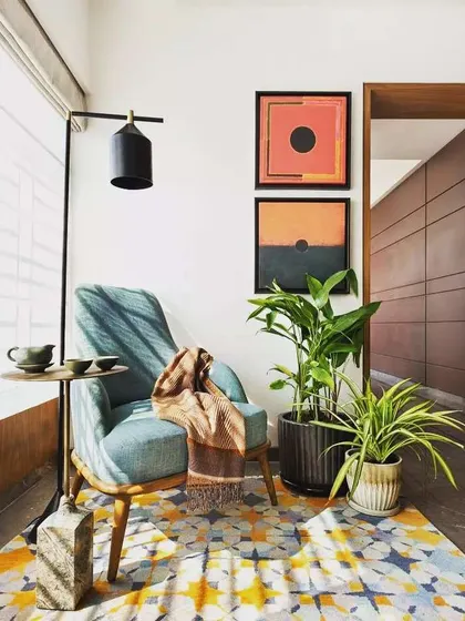 The right plant can complete a room. For this cozy reading nook, I selected two different indoor plants in textured ceramic pots that complement the modern furniture and warm color palette, adding a touch of natural elegance.