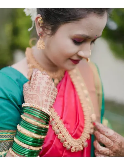 A close-up shot focusing on the details of the model's jewelry and the rich texture of her saree. This type of shot is essential for a complete fashion portfolio.