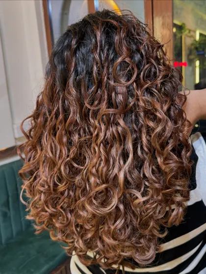 Life's too short for boring hair! These golden-brown highlights were created with Wella professional colors to give a beautiful, sun-kissed glow to her curls.