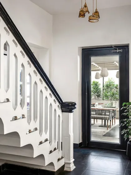 When working with a heritage property, I honor its history. I restored this original staircase, accenting the intricate handrail with a bold black finish and adding patterned tiles to the risers, celebrating the building's soul while giving it a new life.