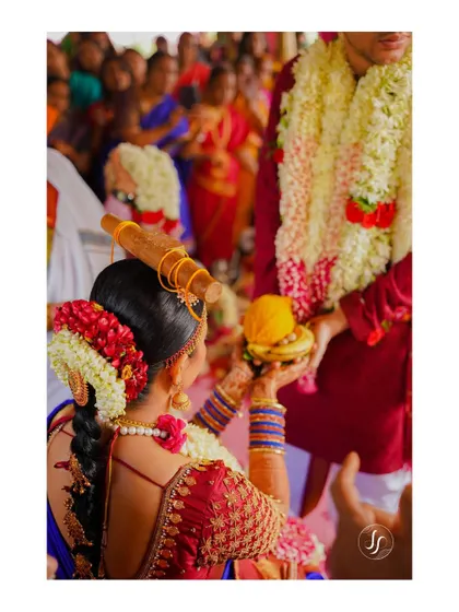 A close-up shot of a traditional South Indian wedding ritual, focusing on the intricate details and cultural significance.