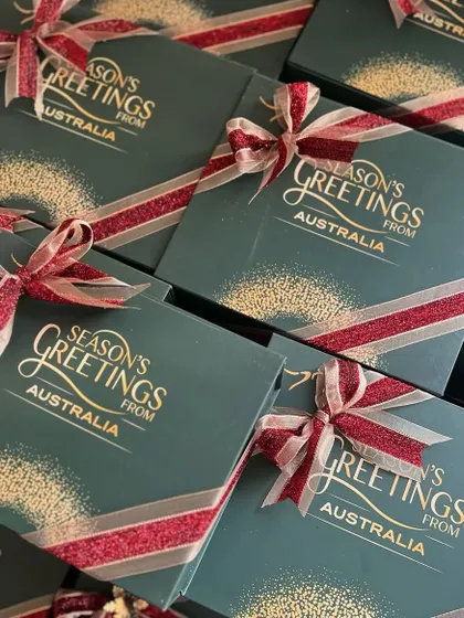The finished Christmas boxes for the Australian Consulate, all tied up with a festive red and gold ribbon. The gold foil lettering on the green box looks so elegant.
