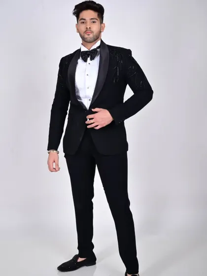 A full-length shot of the embroidered black tuxedo, showcasing its modern design and impeccable tailoring from head to toe.
