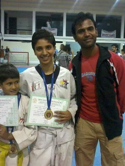 With two of my students, a senior and a junior, both proudly displaying their medals and certificates. We foster growth at every belt level.