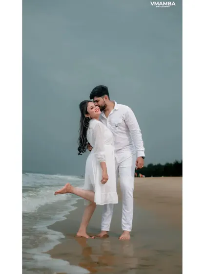 A playful and romantic moment on the beach, with the groom kissing the bride's cheek. We capture the fun and carefree spirit of your relationship.