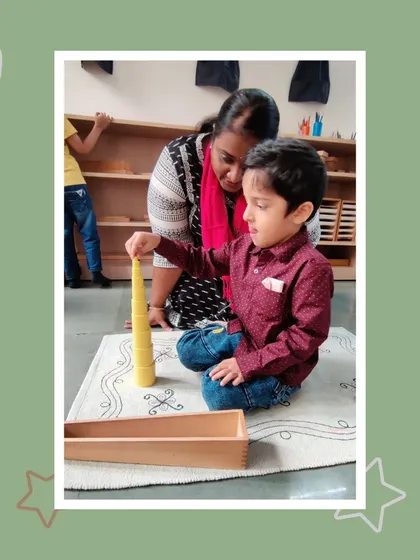 A child demonstrates the yellow knobless cylinders, a material for refining visual discrimination. His parents watch on, seeing the focus and intelligence their son brings to his work.