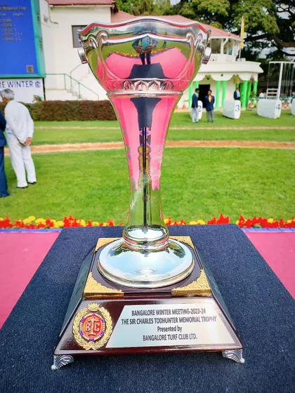 The Sir Charles Todhunter Memorial Trophy, a tall pink and silver glass cup.