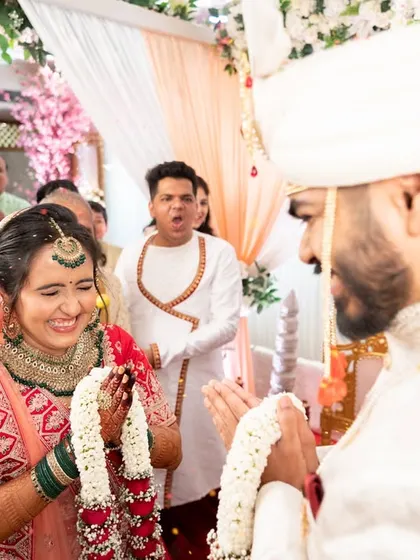 The joy and excitement of the 'varmala' ceremony, with guests cheering for the couple.