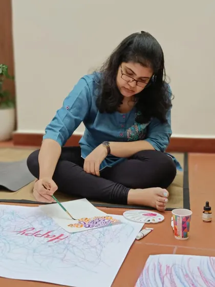 This participant is adding intricate details to her mindful art piece. It's a beautiful process of self-reflection and creative expression.