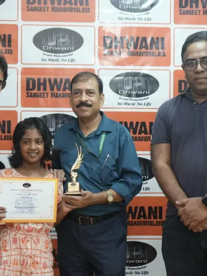 A student receives his award from our faculty, a proud moment for the entire Dhwani team.