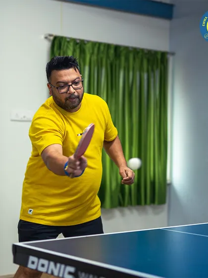 The table's waiting. An adult player practices his forehand during a training session.