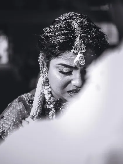An emotional close-up of the bride during a poignant moment in the ceremony. Black and white photography strips away distractions, focusing purely on the feeling.