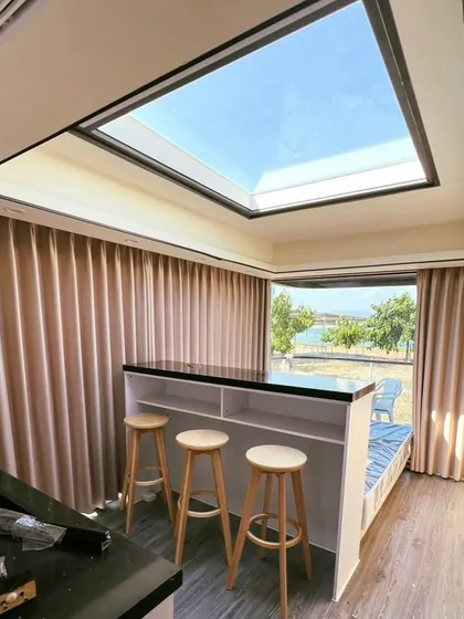 This view shows the bar seating and large skylight in the Space Capsule E8. It's a perfect spot for enjoying a morning coffee while soaking in the natural light.