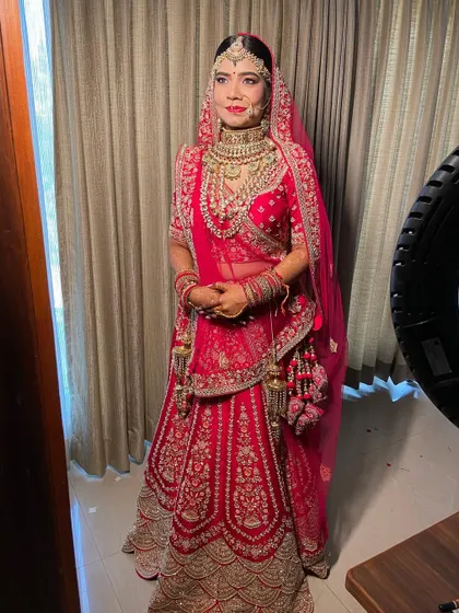 A confident and beautiful bride ready for her wedding. The makeup is bold yet elegant, perfect for a traditional ceremony.