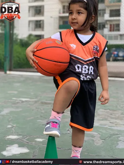 This young athlete is learning balance and coordination by practicing with a cone, a fundamental step in our youth training program.