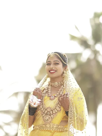 A portrait of the bride, showcasing her complete look, from the intricate jewelry to the perfectly matched custom blouse.