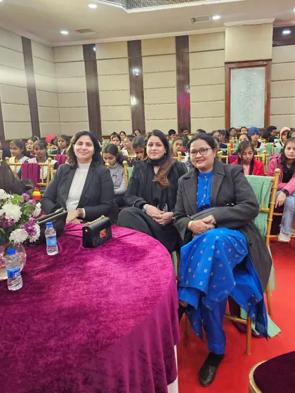 Seated in the audience at the summit, listening to inspiring speakers.