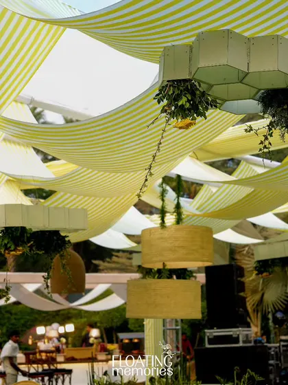 We designed and fabricated these unique honeycomb-shaped light fixtures that floated above the tables. Dripping with fresh greenery and flowers, they were a central design element that perfectly matched the bee theme.