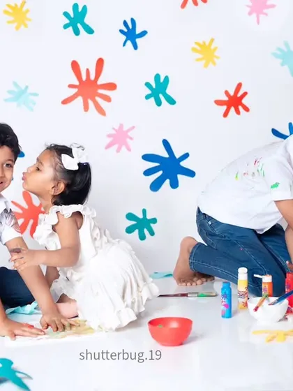 A fun and messy paint-themed shoot with three siblings creating colorful art and beautiful memories together.