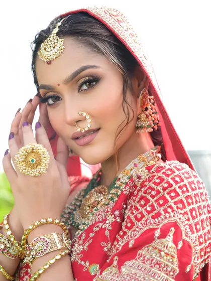 A close-up on the details of this modern bridal look. The winged eyeliner, soft contour, and traditional nose ring come together to create a look that is both fierce and timeless.