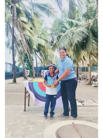 A young archer receiving his medal. These moments build a strong foundation of confidence and sportsmanship.