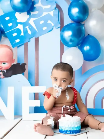A "Boss Baby" themed cake smash is all about having fun and making a mess. This little one is enjoying his first taste of birthday cake.