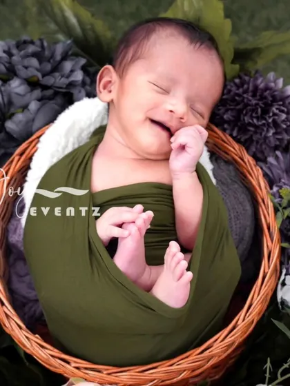 The pure bliss of a newborn's smile is a moment to cherish forever. We specialize in newborn photography in Bangalore, ensuring a safe and comfortable session where your baby is gently swaddled and posed in our cozy, floral-themed props.