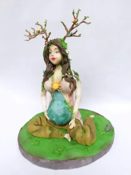 This is one of my favorite artistic creations, a fully sculpted "Mother Earth" cake. Every detail, from the antlers with tiny birds to the flowing hair and the earth-themed belly, is handcrafted from fondant, showcasing my passion for detailed sugar art.