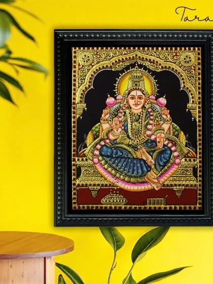 This Tanjore painting of Goddess Lakshmi in a blue saree offers a unique and beautiful color variation. The artwork remains a powerful symbol of prosperity, rendered with our signature craftsmanship.