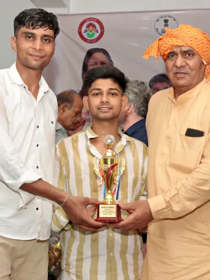 I stand with my student as he is awarded his trophy. My role is to guide them to this stage.