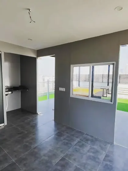 The interior of our modern ACP-paneled room, showing the finished walls and flooring. The large windows and doors are designed to maximize views and natural light.