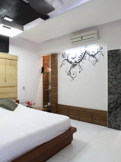 A bedroom in the renovated 'Zingy Home' project. We used a combination of clean lines, a custom wall decal, and a bamboo headboard to create a space that is both modern and warm, demonstrating our attention to personalized details.