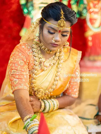 A candid moment from the ceremony, showing the intricate details of the headpiece (Nethi Chutti).