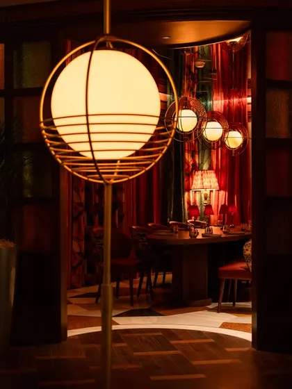A glimpse into one of our private dining areas, where rich colours and elegant lighting create a more intimate and exclusive atmosphere.