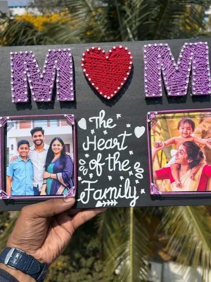 This string art frame makes a perfect gift for Mother's Day. It features the word "MOM" created with string, along with two of your favorite photos and a heartfelt message.