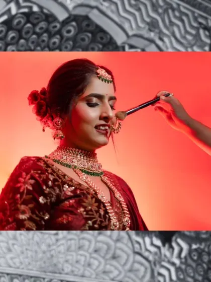 A behind-the-scenes shot of the makeup artist giving the final touches to the bride. This captures the process and anticipation of getting ready.