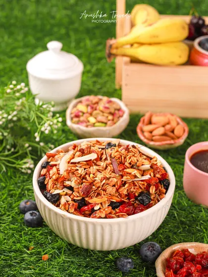Another shot of the granola in a natural setting, surrounded by fresh fruits and nuts.