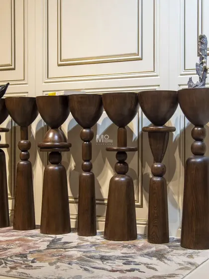 The Seven Pillars Console is where furniture design meets modern, abstract art. Crafted from warm wood, each of the seven vertical pillars is a unique blend of discs, spheres, and hemispheres, creating a functional yet poetic piece.