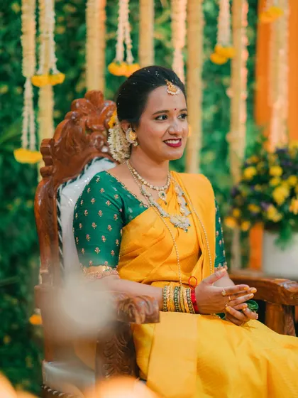 A close-up of the radiant bride during her Haldi ceremony, showcasing her traditional attire against the beautiful decor.