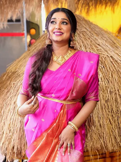 Antara Mitra looking radiant against a rustic backdrop in this classic pink saree.