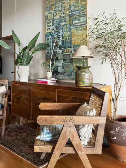 A restored wooden chair and console in the 'Reweave Stories' living room. We believe that furniture with signs of age and use adds immense character and a sense of history to a modern home.