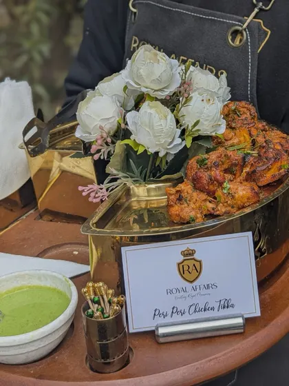 I specialize in passed appetizers that are both delicious and elegantly presented. Here, my staff is serving Peri Peri Chicken Tikka in a beautiful brass platter, ensuring your guests are catered to with professionalism and style.