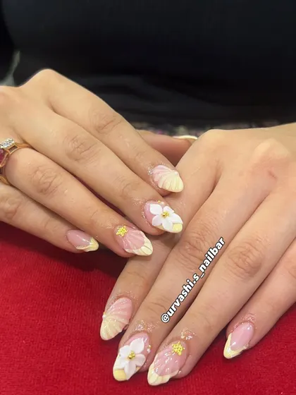 This elegant set features sculpted shell textures on the tips and hand-crafted 3D florals with tiny gold accents. The combination of textures on a soft blush base creates a truly sophisticated and artistic look.
