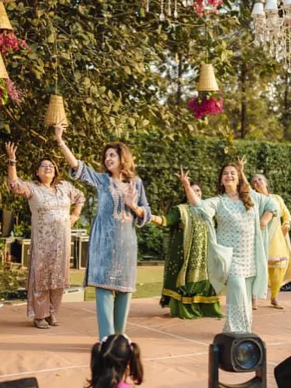 A graceful performance by the ladies of the family. The outdoor setting with hanging chandeliers is just beautiful.