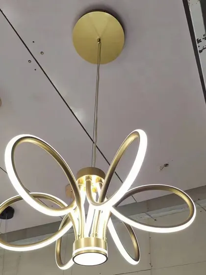A modern floral-inspired chandelier with sleek, curved LED petals. This design offers a contemporary take on a classic chandelier form, perfect for modern homes.