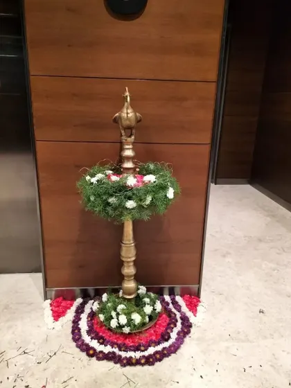Incorporating traditional elements can add a special touch to an inauguration. This decorated brass lamp (diya) and floral rangoli provided a warm and auspicious welcome for an office opening, blending cultural significance with corporate elegance.