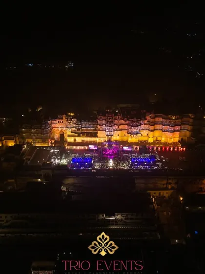 Another breathtaking drone shot capturing the scale of our Sangeet setup against the illuminated City Palace, a testament to our expertise in large-scale palatial events.