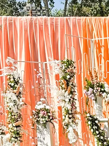 Peach drapes and fresh floral elements create a warm and inviting grand entrance. We work with you to create the perfect mood board for your dream wedding.