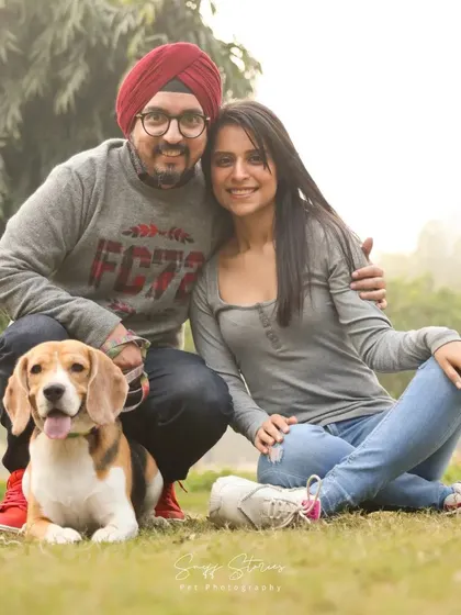 A heartwarming family photo in a Delhi park, featuring a couple with their adorable Beagle, capturing a moment of pure togetherness.