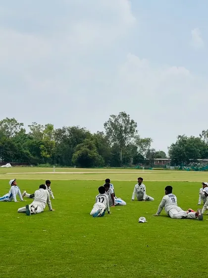 Players relaxing during a stretching session. Flexibility is just as important as strength in cricket.